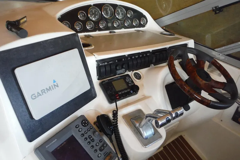 Slide: The Image of 1999 Cruisers 4270 Express helm with Garmin navigation and wood-accented steering wheel. - 29