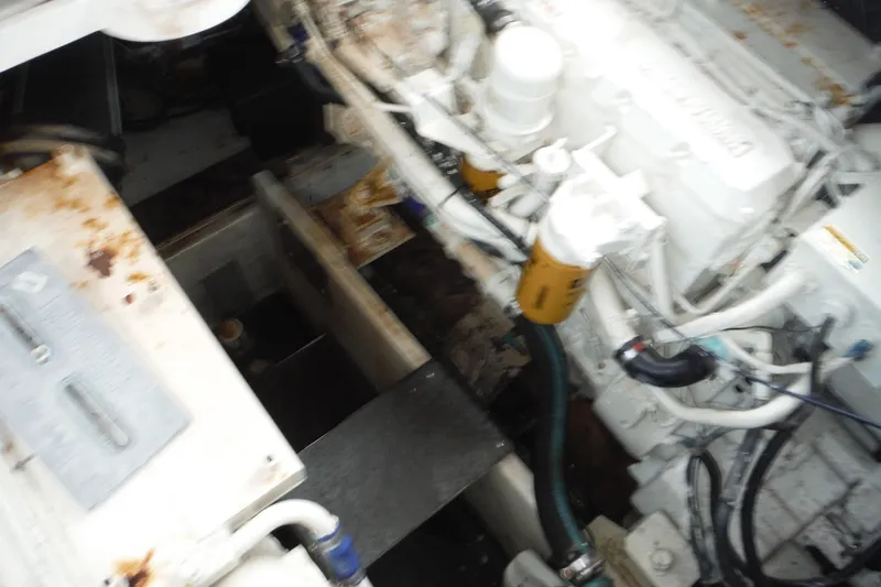 Slide: The Image of Engine compartment of a 1999 Cruisers 4270 Express boat, showing mechanical components. - 32