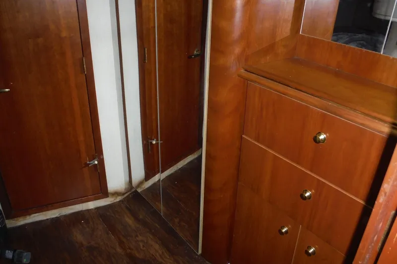 Slide: The Image of 1999 Cruisers 4270 Express interior with wooden cabinets and mirrored door. - 38