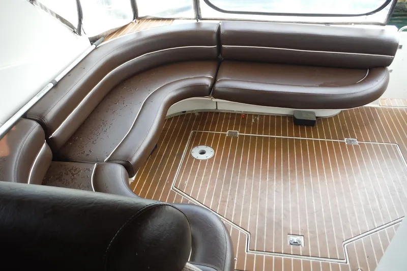 Slide: The Image of 1999 Cruisers 4270 Express boat with brown leather seating and wooden deck. - 42