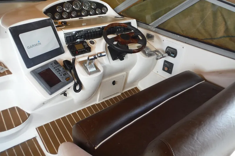 Slide: The Image of 1999 Cruisers 4270 Express helm with Garmin navigation, leather seating, and control panel. - 43