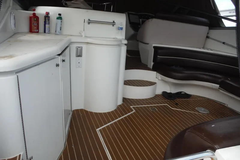 Slide: The Image of 1999 Cruisers 4270 Express interior with seating and cabinetry, featuring wood-patterned flooring. - 5