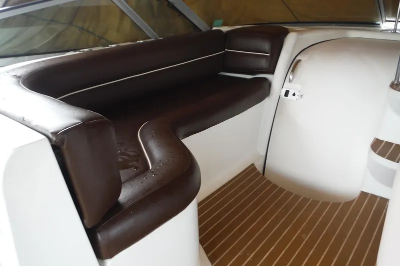Slide: The Image of 1999 Cruisers 4270 Express interior with brown leather seating and wood-patterned flooring. - 7