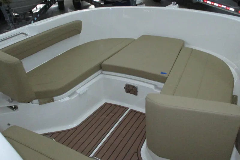 Slide: The Image of 2022 Trophy boat interior with beige cushioned seating and wooden flooring. - 6