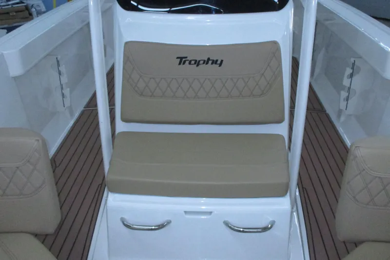 Slide: The Image of 2022 Trophy boat interior with tan cushioned seating and wood-patterned flooring. - 7