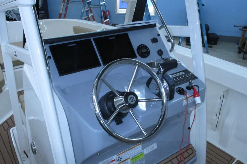 Slide: The Image of 2022 Trophy boat helm with steering wheel and control panel. - 9