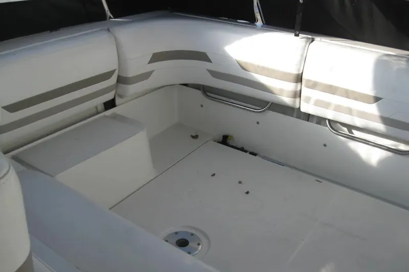 Slide: The Image of 2000 Formula 31 Performance Cruiser interior seating area with white and gray upholstery. - 12