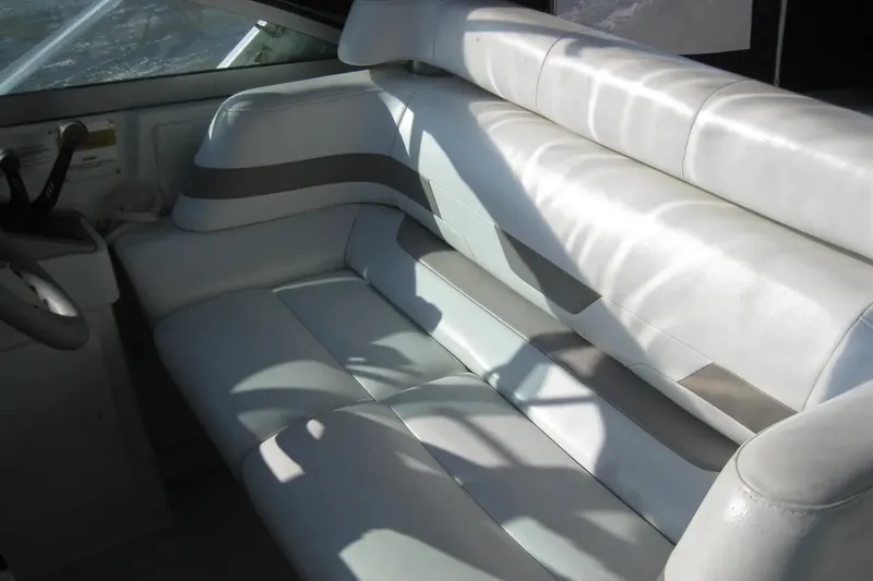Slide: The Image of Interior seating of a 2000 Formula 31 Performance Cruiser boat, featuring white upholstery. - 18