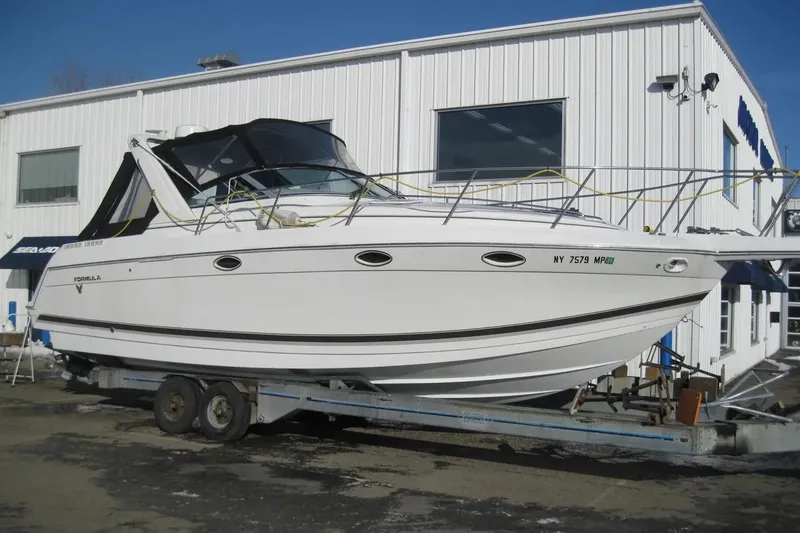 Slide: The Image of 2000 Formula 31 Performance Cruiser on trailer outside a white building. - 2