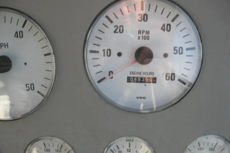 Slide: The Image of Dashboard gauges of a 2000 Formula 31 Performance Cruiser showing RPM and engine hours. - 22