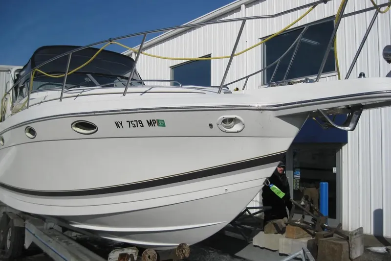 Slide: The Image of 2000 Formula 31 Performance Cruiser boat on trailer outside a building. - 3