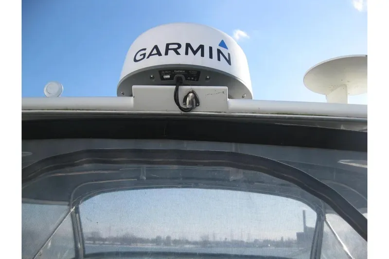Slide: The Image of Garmin radar on 2000 Formula 31 Performance Cruiser against blue sky. - 35
