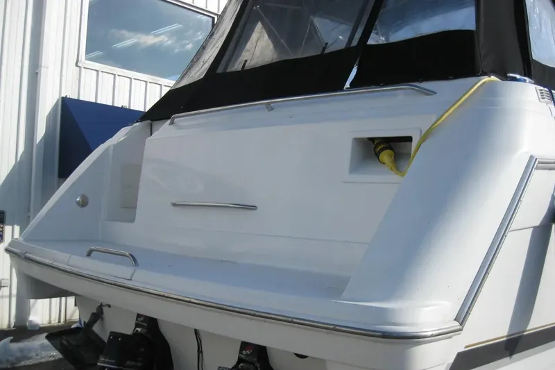 Slide: The Image of 2000 Formula 31 Performance Cruiser boat stern view with black canopy and yellow power cable. - 5