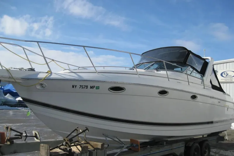 Slide: The Image of 2000 Formula 31 Performance Cruiser boat on trailer, side view, clear sky background. - 8