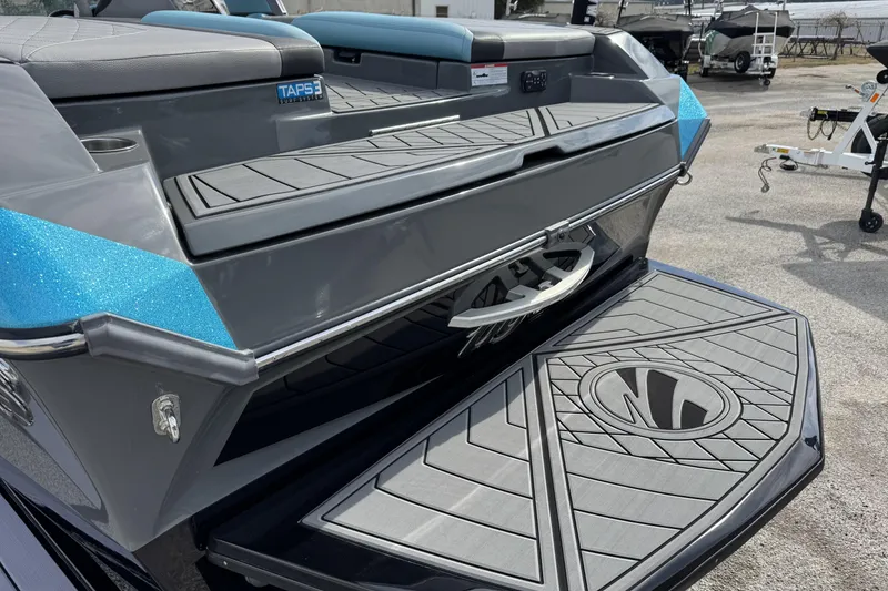 Slide: The Image of 2018 Tigé RZX3 boat rear view with TAPS 3 surf system and stylish deck design. - 7