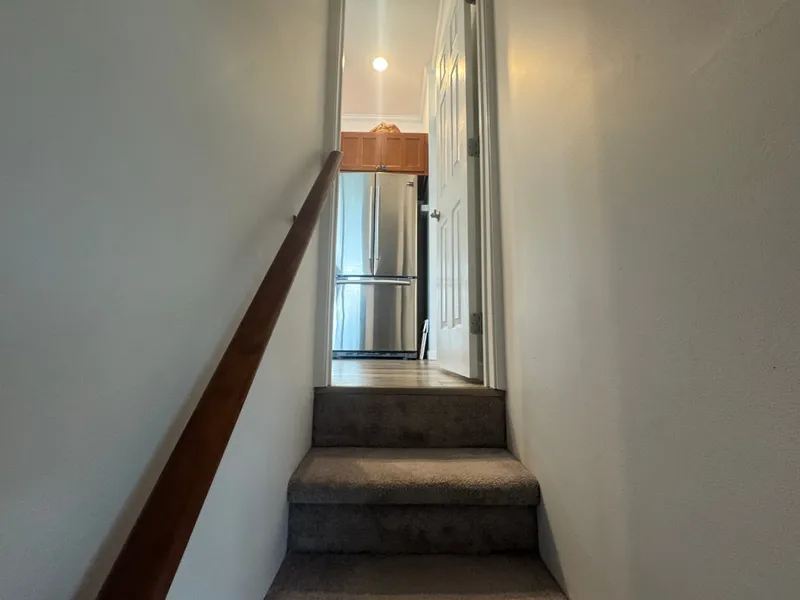 Slide: The Image of Staircase in Harbor Cottage Tiny Boat with stainless steel fridge. - 35