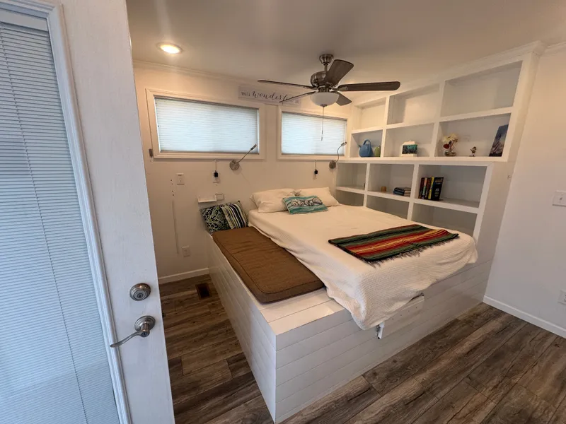 Slide: The Image of Interior of 2019 Harbor Cottage Tiny Boat with bed and shelves. - 37