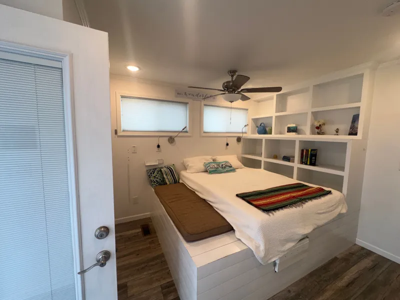 Slide: The Image of Interior of Harbor Cottage Cozy Cottage Tiny Boat, bedroom with bed and shelves. - 38