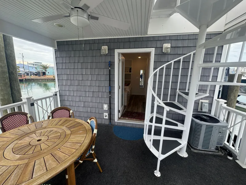 Slide: The Image of Cozy houseboat with spiral staircase and wooden table on the deck. - 40