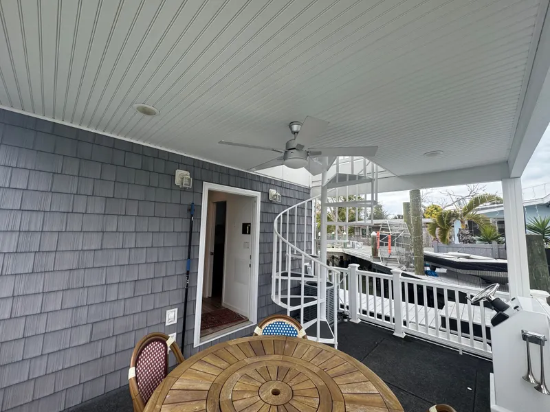 Slide: The Image of Harbor Cottage Tiny Boat with spiral staircase and wooden table on deck. - 42
