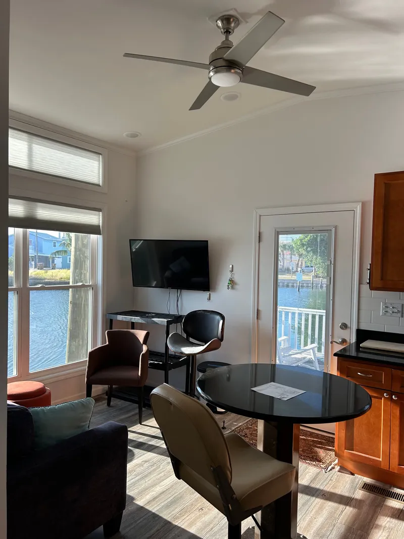 Slide: The Image of Cozy 2019 Harbor Cottage tiny boat with porch and rocking chairs. - 8