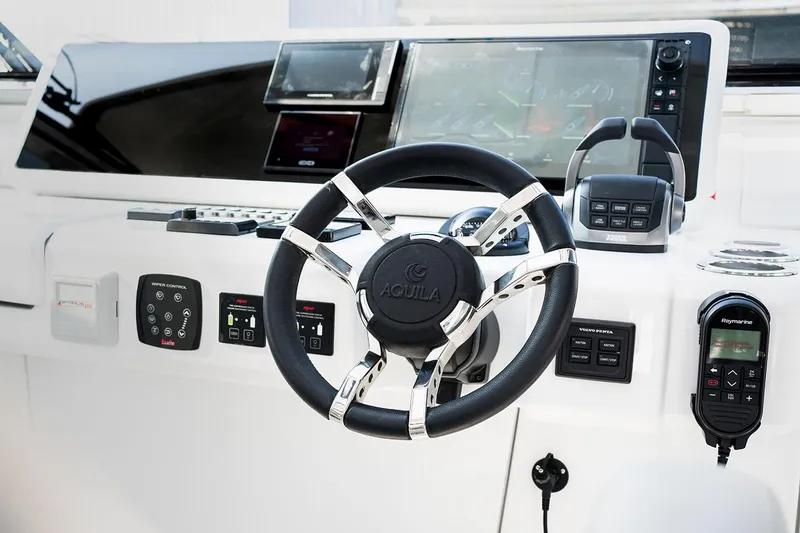 Slide: The Image of Manufacturer Provided Image: Steering wheel and control panel of 2026 Aquila 54 Yacht, featuring advanced navigation technology. - 7