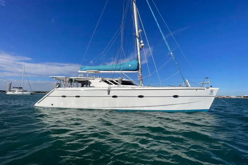 The Image of 2010 Knysna 480 catamaran sailing on clear blue waters under a bright sky. - 0