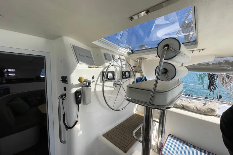 Slide: The Image of Knysna 480 yacht interior with ocean view, fishing rods, and potted plant on table. - 10