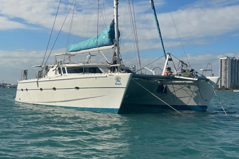 Slide: The Image of Sailing catamaran Knysna 480, 2010 model, on calm waters under a clear blue sky. - 2