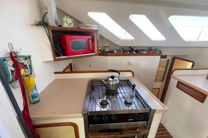 Slide: The Image of Cozy cabin interior of 2010 Knysna 480 yacht with skylight and wooden accents. - 20