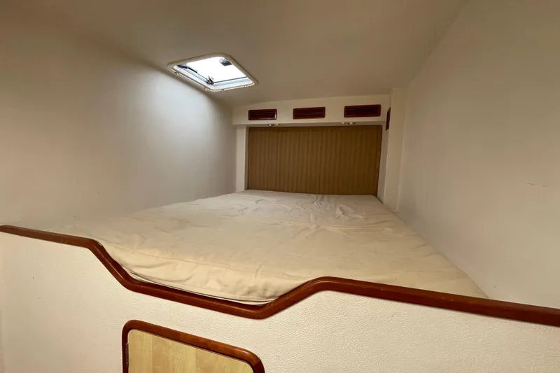 Slide: The Image of Cozy cabin interior of 2010 Knysna 480 yacht with red bedding and wooden accents. - 26