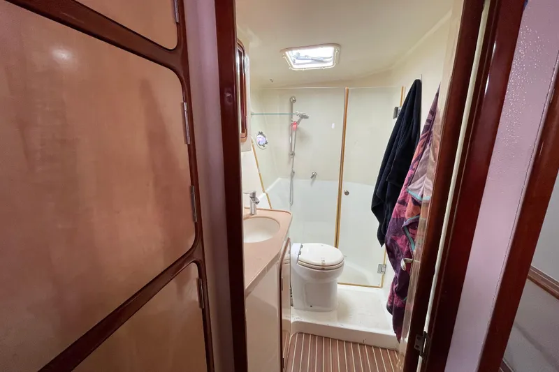 Slide: The Image of Compact bathroom in 2010 Knysna 480 yacht with sink, mirror, and shower. - 35