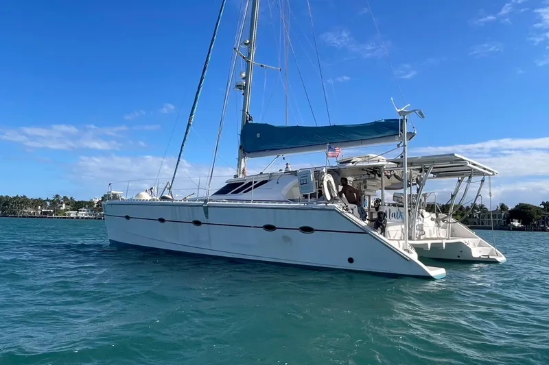 Slide: The Image of Knysna 480 yacht interior with table, plant, and ocean view, 2010 model. - 9