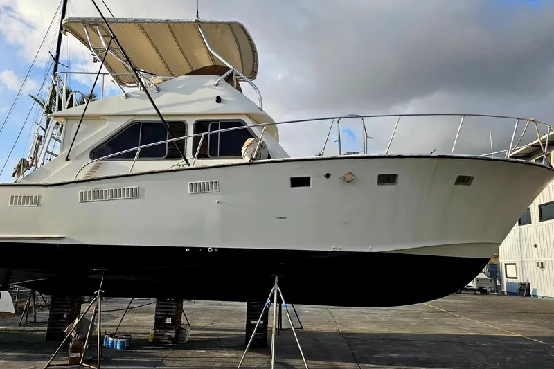 Slide: The Image of 1977 Pacifica 44 Convertible yacht on dry dock, showcasing sleek design and sturdy build. - 2