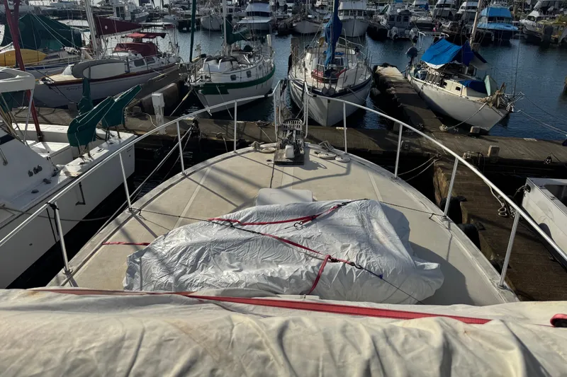 Slide: The Image of 1977 Pacifica 44 Convertible yacht docked in a bustling marina. - 22