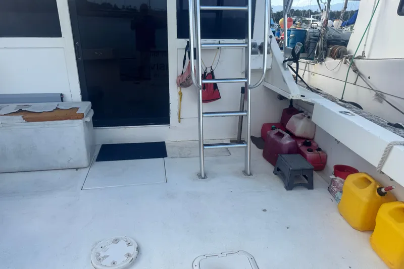 Slide: The Image of 1977 Pacifica 44 Convertible boat deck with ladder, fuel containers, and storage. - 8