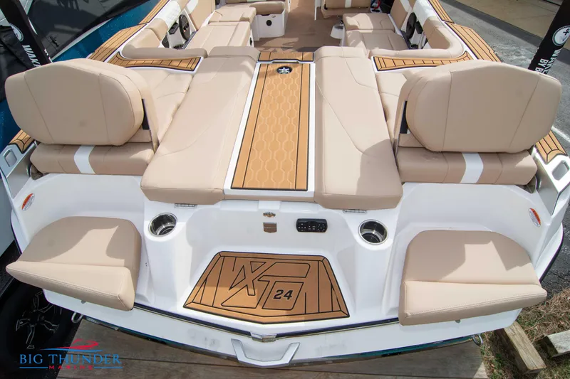 Slide: The Image of 2024 MasterCraft NXT24 boat interior with beige seating and teak-style flooring. - 10