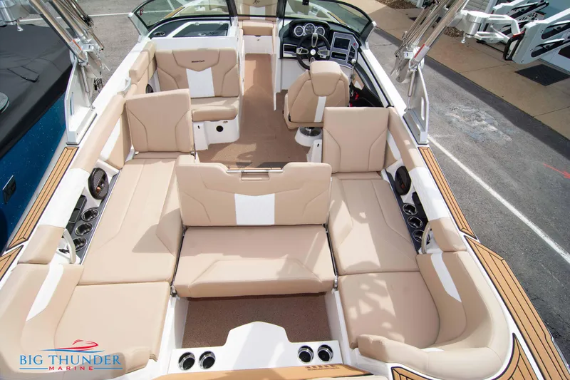 Slide: The Image of 2024 MasterCraft NXT24 boat interior with beige seating and modern dashboard. - 14