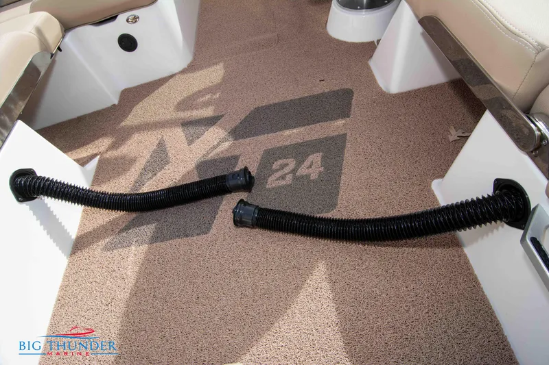 Slide: The Image of 2024 MasterCraft NXT24 boat interior with carpet and flexible hoses. - 26