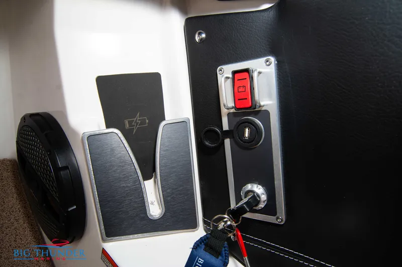 Slide: The Image of 2024 MasterCraft NXT24 boat dashboard with ignition key and control panel. - 31