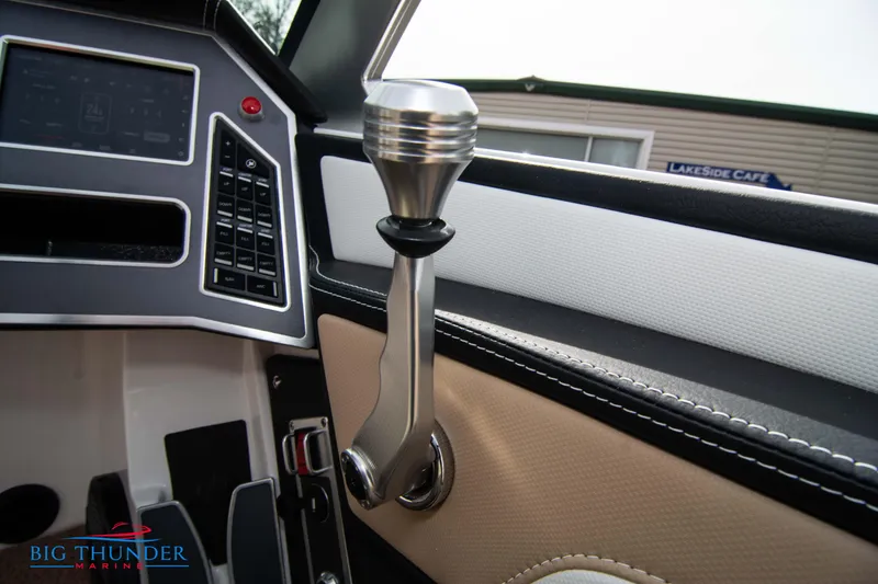 Slide: The Image of 2024 MasterCraft NXT24 boat interior with control panel and gear lever. - 32