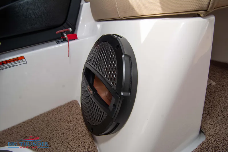 Slide: The Image of 2024 MasterCraft NXT24 interior speaker detail with beige seating and carpet. - 36