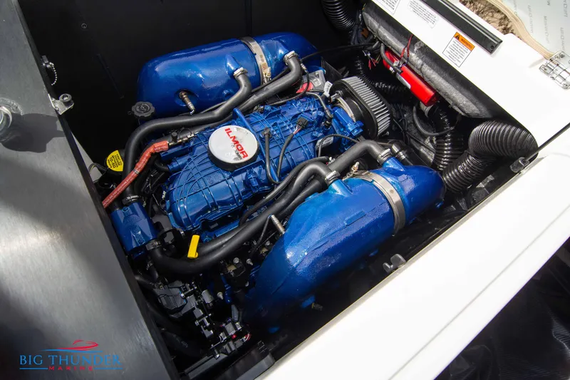 Slide: The Image of 2024 MasterCraft NXT24 engine compartment with Ilmor engine, showcasing blue components and detailed mechanics. - 51