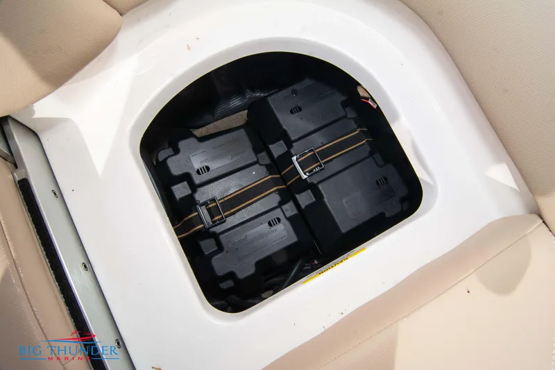 Slide: The Image of 2024 MasterCraft NXT24 boat battery compartment with secured dual batteries. - 56