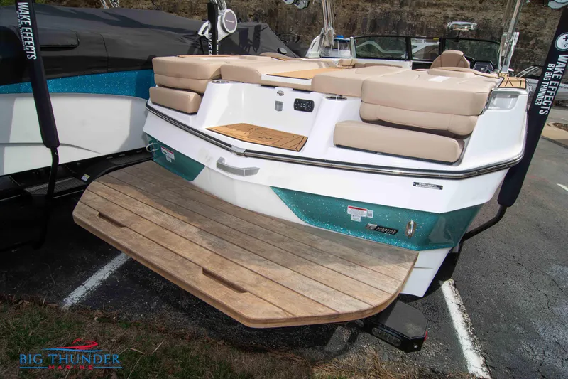 Slide: The Image of 2024 MasterCraft NXT24 boat with teak swim platform and cushioned seating. - 8