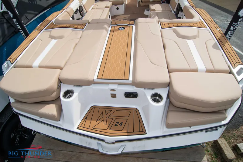 Slide: The Image of 2024 MasterCraft NXT24 boat with beige seating and teak-style flooring. - 9