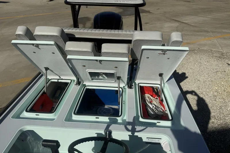 Slide: The Image of 2023 Hell's Bay Marquesa boat with open storage compartments and seating. - 14