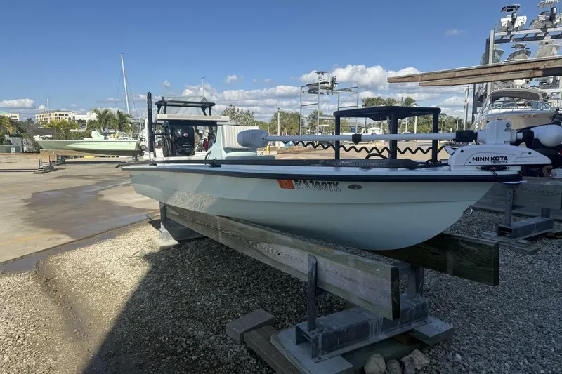 Slide: The Image of 2023 Hell's Bay Marquesa boat on a dock with Minn Kota motor. - 4