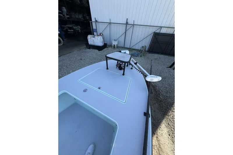 Slide: The Image of 2023 Hell's Bay Marquesa boat, docked, showcasing deck and equipment. - 5