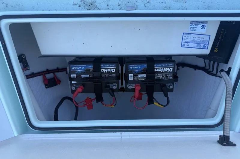 Slide: The Image of 2023 Hell's Bay Marquesa boat battery compartment with dual DieHard Platinum batteries. - 6